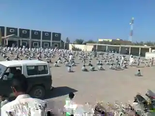 A large outdoor gathering of students at The Oasis School