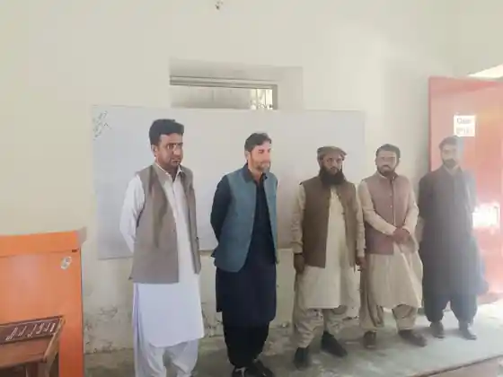 Teachers standing together in a classroom at The Oasis School